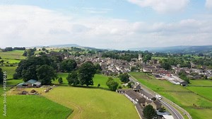Aerial footage of the beautiful town of Middleham in Leyburn in North Yorkshire in the UK showing the British countryside town and the historic Middleham Castle on a sunny day in the summer time