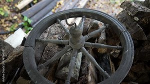 Vintage spinning wheel on a pile of wood