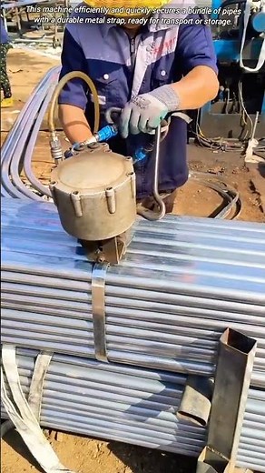Metal pipe bundling machine in action.