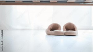 Kid's feet putting slippers on. The child wakes up early in the morning. Feet of a teenage child in slippers. Stock Video