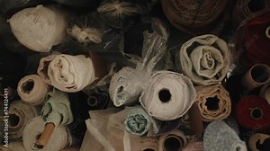 Textile factory. spinning of the fabric roll. A large warehouse of textile products and goods. Sewing or furniture production. Colorful fashion fabric samples