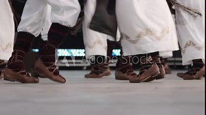 Traditional romanian folklore dancers in traditional costumes dancing on stage in slow motion