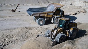 Heavy mining truck and bulldozer in quarry