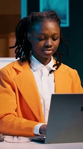 Vertical Video Portrait of dedicated pupil studying class materials and notes to increase knowledge, working from home on her projects. Student researching for assignments using web libraries. Camera
