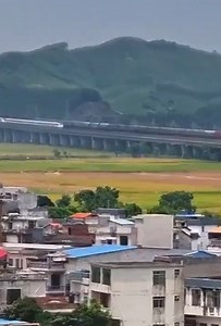The footage shows Fuxing bullet train overtaking a regular train in South China's Guangxi Zhuang Autonomous Region. Have you ever traveled on a high-speed train? How do you feel? #ChinaQandA For more：https://english.cctv.com/ | CCTV
