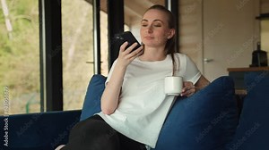 A woman with a phone in her hands speaks on a speakerphone, using a virtual digital voice recognition assistant to search, records an audio message on a smartphone at home