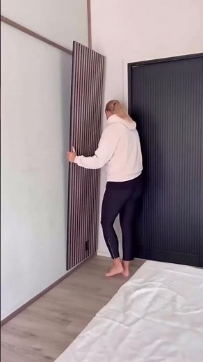 In this living room with high ceilings, our Walnut Akupanels bring warmth and balance to the open