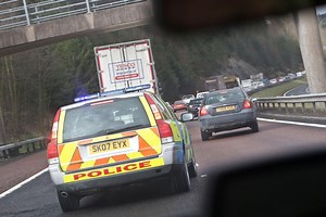 What should I do when there's an emergency vehicle behind me?