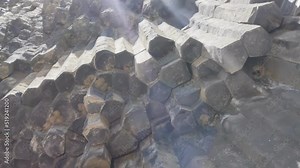 Looking up: A rare variety of volcanic rocks in the form of hexagonal basalt pillars vertically adjacent to each other. Symphony of Stones in the Armenian Garni. tourist attraction