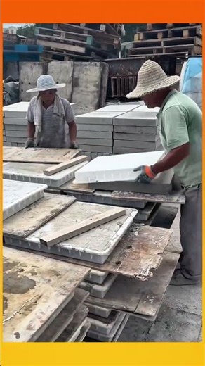Forming large square cement blocks using molds for a solid, uniform finish.