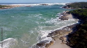 Strong waves cracking down on rocks at a beach