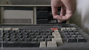 Inserting a floppy disk in retro personal computer