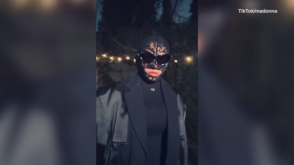 Madonna dons lace face mask and black ensemble while posing for her TikTok fans