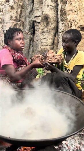 Hadzabe Women Cooking and Eating Fresh Baboon Meat Under a Baobab Tree