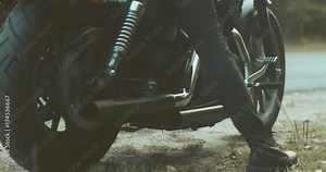 Female biker sitting on her motorcycle on a forest road. 4K UHD 60 FPS