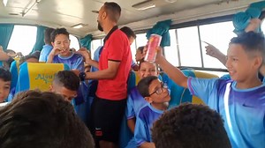 Boys in Blue Jerseys Enjoy Bus Ride Activities