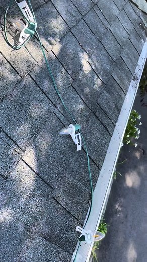 This is how we decorate a Hallmark movie set for the Christmas lights on gutter guards in this scene. This is supposed to look like a Spanish style Christmas for the three kings i think. we are using the tough clips to go slide over the C9 LED bulbs. ##ledlights##hallmark##behindthescenes##christmaslights