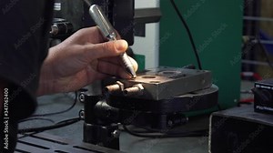 Micro welding. Operator use electro spark engraving equipment on close-up. Welding small metal parts.