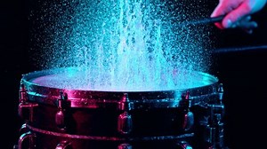 Super Slow Motion Shot of Drum Hit and Splashing Water at 1000 fps.