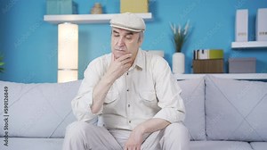 The old man, afflicted with loneliness and sadness, is crying. The old man, saddened by sadness and grief at home, is crying.