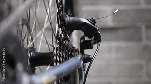 Bicycle drivetrain, cassette and chain. Bicycle repair. Bicycle workshop. Spinning a wheel to check and tune a bicycle. Slow motion