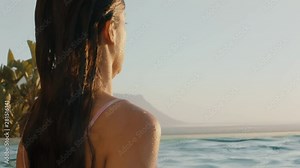 beautiful woman swimming in pool at luxury hotel spa enjoying holiday resort lifestyle at sunset 4k