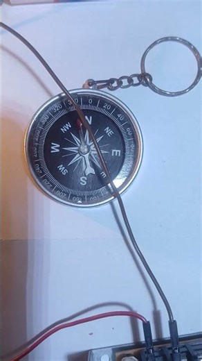 Oersted's experiment demonstration using a 5 Volt power supply, 2 magnetic compasses & 6 Volts bulb