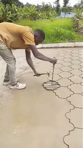 Manual concrete stamping creating decorative patterned pavement design #popular #construction #work