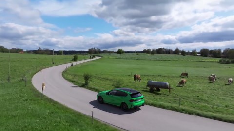 The new BMW M135 xDrive in Signal Green Driving in the country
