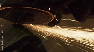 Using the industrial grinding equipment in the production room. Industrial grinding equipment for manufacturing of the metal products. Industrial equipment is grinding the metal parts in a workshop.