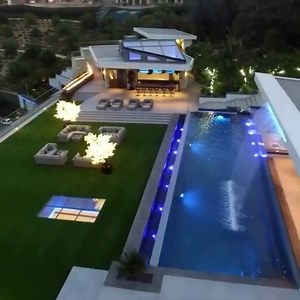 A quick look inside Dan Bilzerian #BelAir Estate! A 31,000 sq ft mega #mansion developed by Donald Bolin. The ultra #contemporary beast sits high above the roadway and behind a metal gate. The motorcourt can hold up to 70 #cars, and a garage space for 14 more. This #home boasts 12 bedrooms, 23 bathrooms, two lane #bowling alley, 5,600 sq ft master #bedroom, full #spa room, a movie #theatre, a chromed out pool table, rooftop tennis court, zero edge swimming #pool, putting green and so much more! 