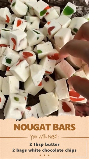Easy Nougat Bars Ingredients 2 tbsp butter 2 bags white chocolate chips (225 g each) 2 bags mini marshmallows (250 g each) 1½ cups chopped red & green gumdrops Instructions Line an 8×8 baking dish with parchment paper. Cut gumdrops in half and set aside. In a double boiler over gentle simmering water, melt the butter, white chocolate chips, and marshmallows together, stirring continuously until smooth. Do not boil. Remove from heat and let cool for 2 minutes. Stir in the gumdrops and mix well. P