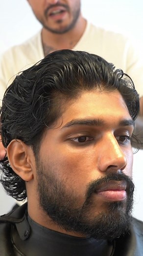Medium length slick back or wavy textured haircut