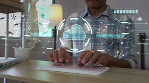 Download A men using computer for connecting to a cloud computing data hologram. business digital background. for free