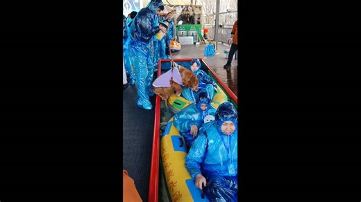 Dog joins owners on inflatable ride down water slide in Liaoning, China