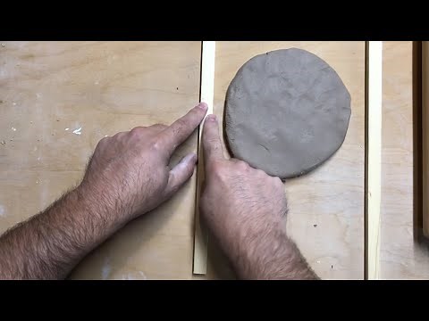 Rolling out a slab of clay