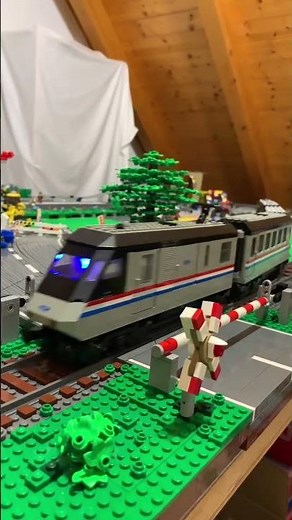 Lego metroliner and intercity trains running on a city layout