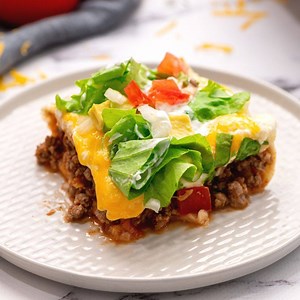 This Mexican Lasagna is made with seasoned beef, a creamy filling, flour tortillas, and of course, cheese. This Tex Mex spin on a classic Italian dish is an easy recipe that is sure to be a family favorite. https://amindfullmom.com/mexican-lasagna/ | A Mind "Full" Mom