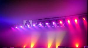 Nightclub Spotlight: Vibrant lights illuminate the stage, setting the scene for a dynamic dance party amidst pulsating music and swirling laser beams