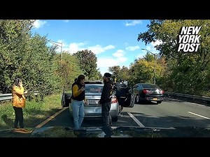 Chaotic footage shows suspected fraudsters reverse into car, fake injuries before noticing dashcam