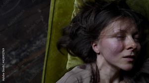 excited middle-aged woman is caressing herself in room, closeup of face