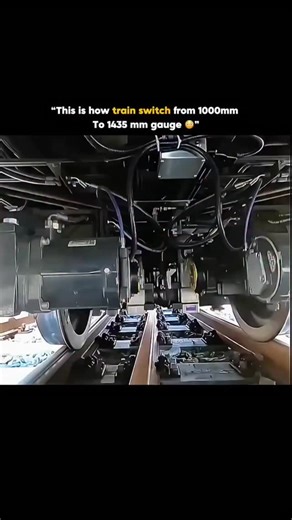 TechWithRahul on Instagram: "Trains can switch from a 1000 mm (meter gauge) to a 1435 mm (standard gauge) without stopping by using a **variable-gauge axle (VGA) system**, where the wheels are not fixed rigidly to the axle and can slide sideways; as the train slowly rolls through a special **gauge-changing installation**, guide rails unlock the wheelsets, push the wheels inward or outward to the new spacing, and then automatically relock them at 1435 mm, all while the train keeps moving at low s