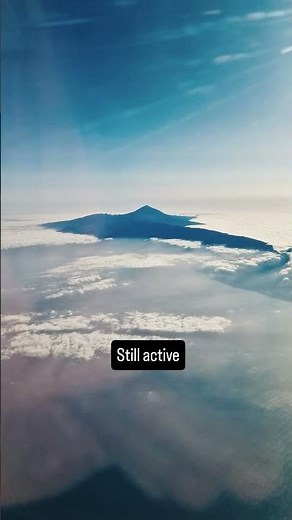 That volcano above the clouds is Mount Teide in Tenerife, Canary Islands.