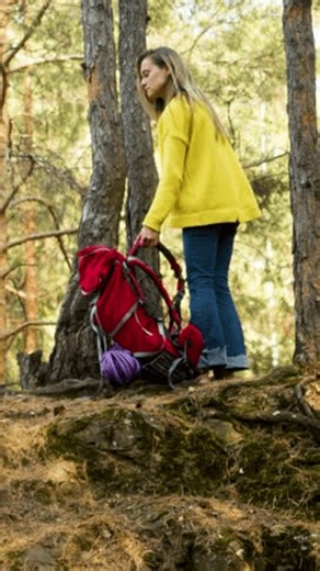 clip-3980434507-fhd-vertical-footage-young-woman-pine-forest