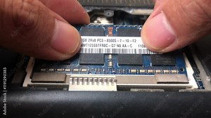 Professional technician installs laptop ram memory. Repairman fixes and maintains computers. Memory upgrade. Desktop computer hardware