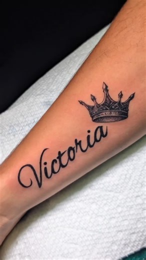 Juan Alain Monteagudo Quevedo on Instagram: "Un tatuaje fino y elegante con el nombre Victoria en lettering fluido, coronado por una corona que simboliza fuerza, orgullo y realeza. Un diseño limpio y atemporal que honra un nombre con poder y significado. / A clean and elegant tattoo featuring the name Victoria in flowing script, crowned with a detailed crown symbolizing strength, pride, and royalty. A timeless design that honors a powerful name. #VictoriaTattoo #NameTattoo #CrownTattoo #Letterin