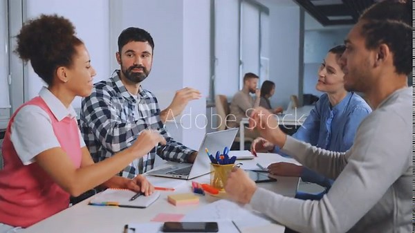 Team members collaborate and exchange handshakes during office meeting, fostering teamwork and mutual respect in professional environment