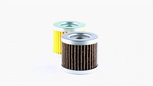 Download Engine oil filters of used and unused yellow and black motor oil filters rotate on a white background for free