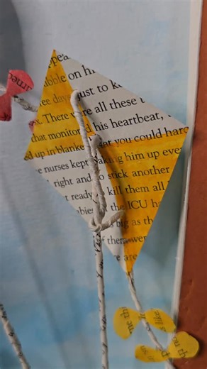 "Set Free the Kites" book sculpture. Created with a book of the same name. The background has been painted with watercolor. Available. #booksculpture #bookcraft #bookart #kite #sky #watercolor | Jodi Harvey Art