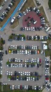 A busy parking lot in rush hour. Different types and colored vehicles parking in timelapse.